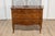 A Tuscan walnut and mahogany commode from circa 1890 with four drawers, banded inlay and bronze hardware. This exquisite...