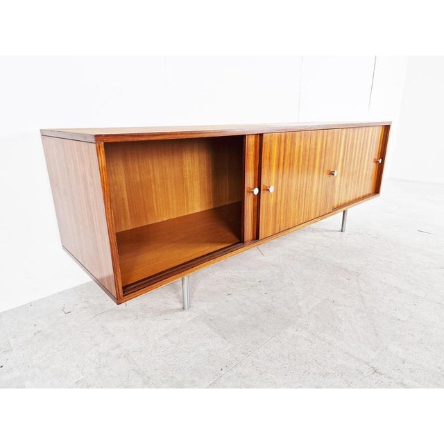 Timeless mid century sideboard by Alfred Hendrickx. The sideboard offers a lot of storage space, because it's deeper then...