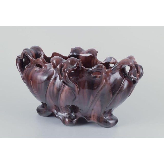 Jérôme Massier for Vallauris, France. Large Art Nouveau jardiniere in earthenware. with four handles and on feet. Organic...