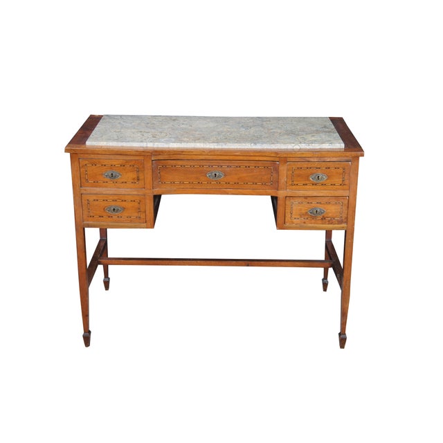 This antique 19th Century mahogany Sheraton-style writing desk is a refined example of Neoclassical design, balancing a...