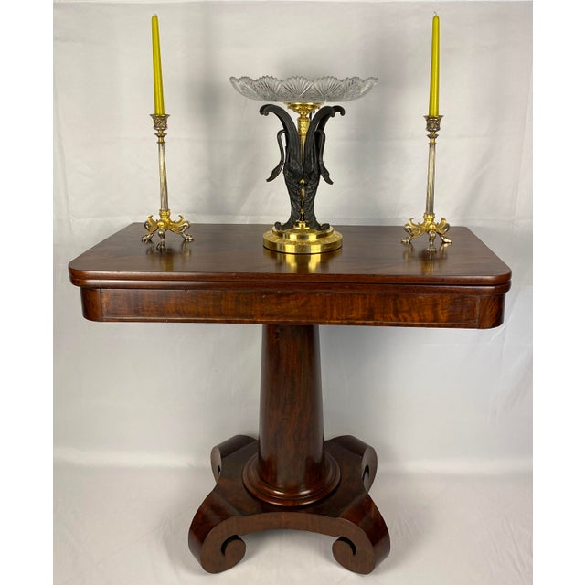 Elegant American Empire style game table, circa 1835. This versatile piece showcases classic design with a practical...