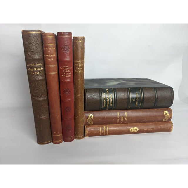 An evocative collection of seven antique and early vintage Scandinavian books, featuring richly aged leather bindings,...