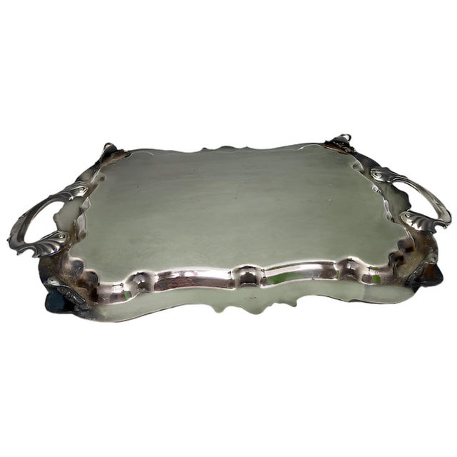 Expertly crafted by the renowned Birmingham Silver Company, this large Victorian serving tray boasts elegant feet and...
