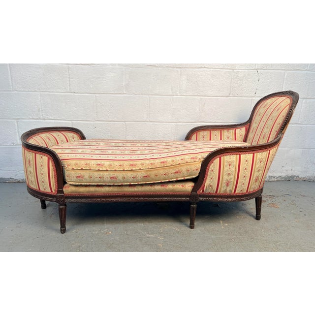 This elegant French provincial chaise lounge settee, crafted in the Louis XV style, features graceful curves, carved...