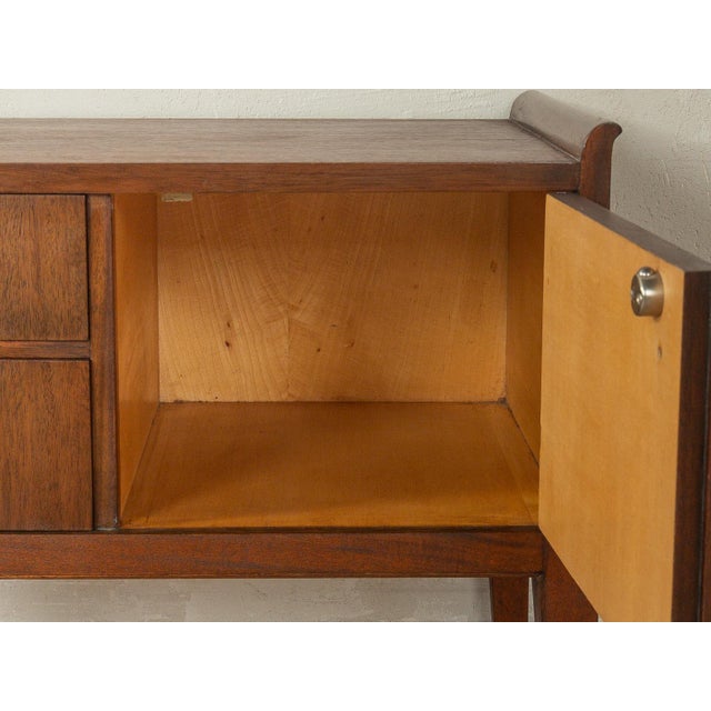 Beautiful bedside tables from the 1920s. High-quality walnut veneer frame with two drawers and one door. This offer...