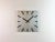 Industrial wall clock produced by Pragotron in former Czechoslovakia during the 1980s. It features a silver square...