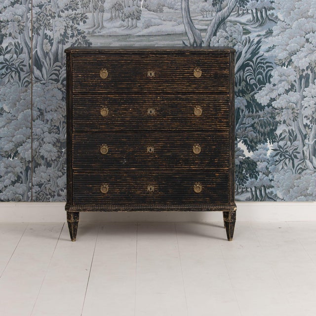 A handsome early Gustavian period commode with reeded drawer fronts and canted and fluted corner posts, raised upon...
