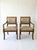 A stately and refined pair of French Empire style armchairs. Crafted in solid wood with ebonized and gold-gilt acanthus...