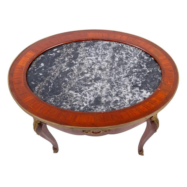 Louis XV Style Gilt Metal Mounted Kingwood Black and Grey Marble Top Oval Low Table, early 20th century, the crossbanded...