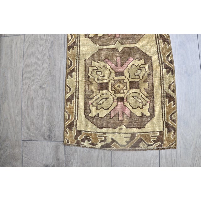 This is a vintage Turkish Oushak rug from the 1960s. The piece was hand-knotted.