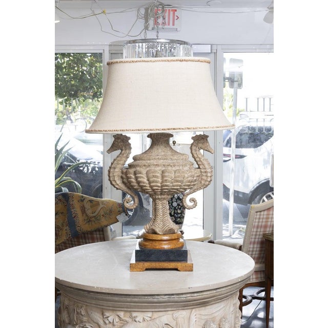 An impressive pair of monumental table lamps crafted from finely carved stone in the form of classical urns flanked by...