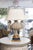 An impressive pair of monumental table lamps crafted from finely carved stone in the form of classical urns flanked by...
