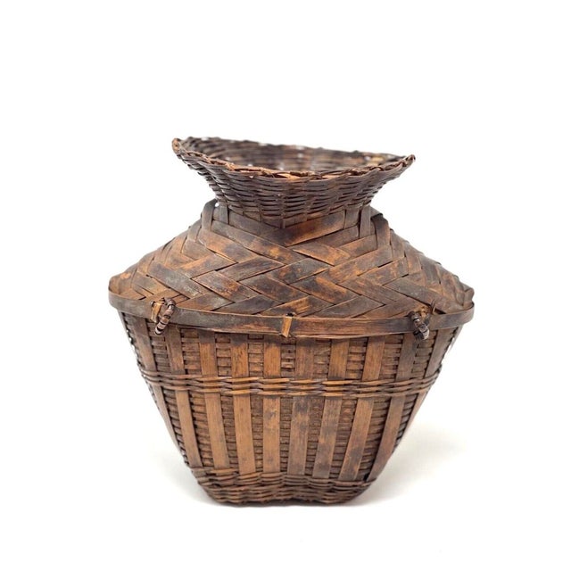 20th C Asian bamboo grain gathering basket. Handmade rattan straps weaved tightly makes this bottle neck design fully...