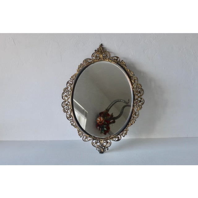 Vintage Italian Baroque Style Ornate Filigree Brass Oval Wall Mirror. Some surfaces are brass while others are brass...