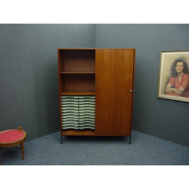 Rare office cabinet by Herbert Hirche. Made in the 1960s. Material: wood and veneered with teak. from first owner and in...