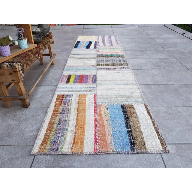 This is a vintage Turkish Oushak rug from the Mid 20th Century. The piece was hand-knotted.