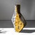 Fragment ochre i stands as an architectural object whose angular silhouette reads as much like fractured geology as a...