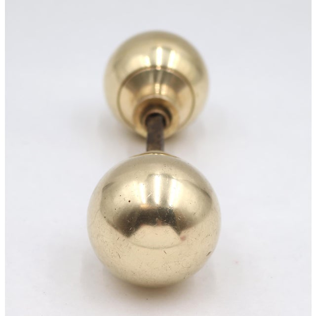 Reclaimed Modern style door knobs made of polished brass with a ball shape. Priced as a pair of knobs with a spindle. Good...