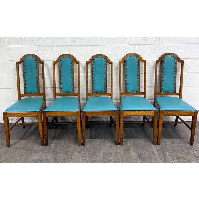 This is a stunning set of five vintage Mission / Arts & Crafts oak dining chairs featuring tall arched backs with...