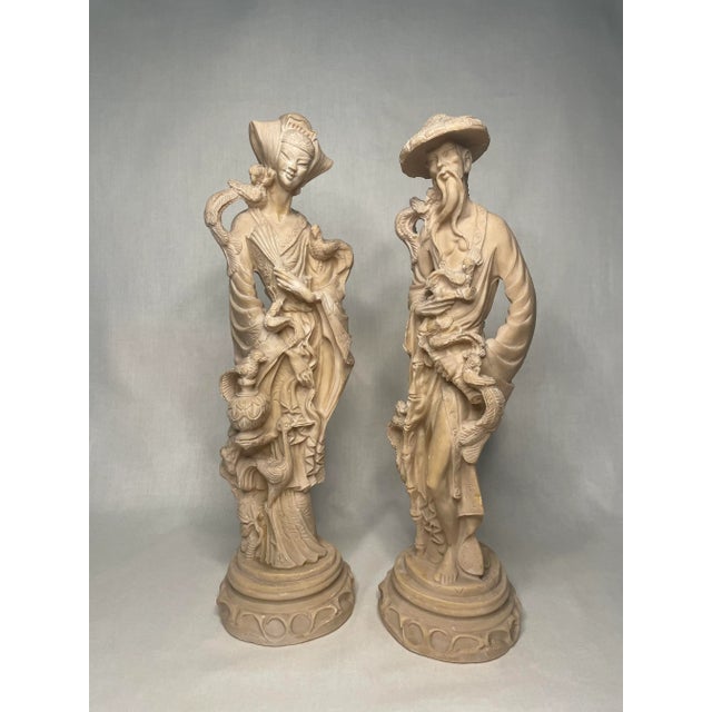 This delightful pair of chinoiserie figurines are stately in detail and height. The pair made out of resin depicts a woman...