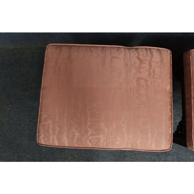 Pair of Ethan Allen chinoiserie footstools with dark wood frames and upholstered rectangular seats in a soft blush pink...