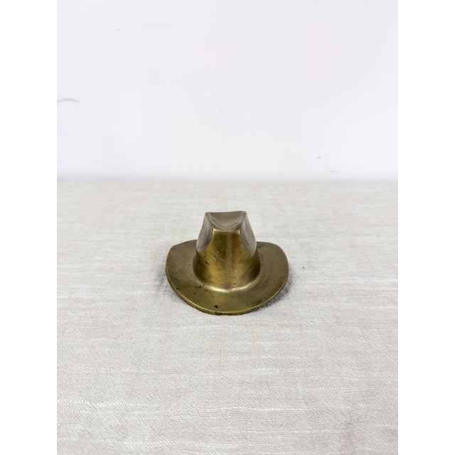 Add a touch of Western mid century charm to your space with this vintage solid brass cowboy hat ashtray. Featuring a...