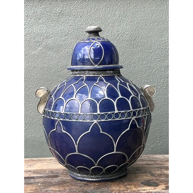 Bring the exotic allure of North Africa into your home with this striking Moroccan lidded urn. Defined by its deep, high-...