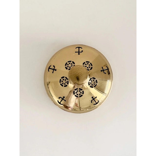 Vintage ship’s decanter made in Sweden in the 1950s. Clear glass bottle set within a brass frame with nautical cutouts,...