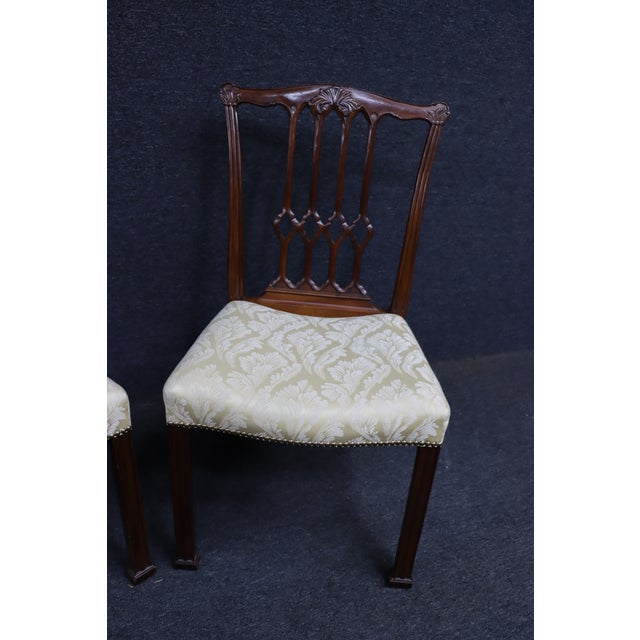 Elegant pair of mahogany side chairs by John Widdicomb in the Chippendale style. Each chair features a finely carved back...