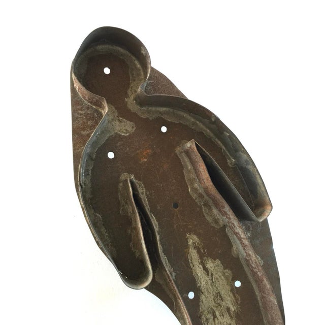Here is a large primitive cookie cutter. It’s in the shape of a simple human form. Made of tin, this cookie cutter is 9...