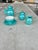 This stunning set is finished in a high-gloss, shimmering teal glaze that catches the light beautifully, accented by...