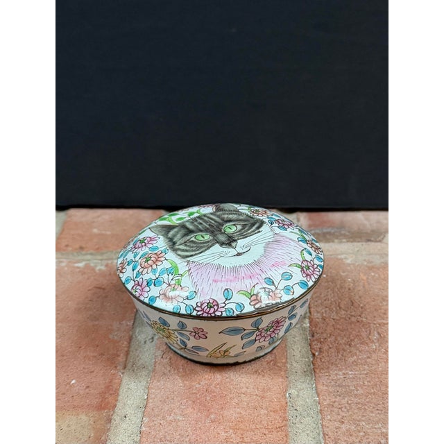 Vintage enameled copper box with a hand painted stylized kitty cat portrait on the hinged lid. Decorated with flowers on...