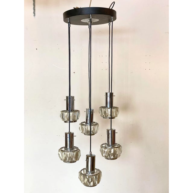 60s chandelier consisting of 6 adjustable suspension, chromed steel speakers and molated crystals, lacquered metal cover...