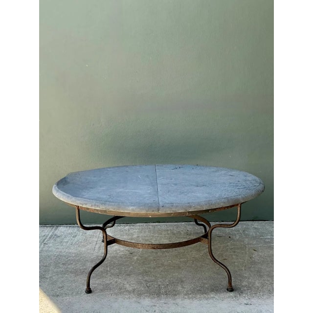 Crafted with monumental scale and enduring materials, this vintage round dining table features a thick, two-piece solid...