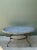 Crafted with monumental scale and enduring materials, this vintage round dining table features a thick, two-piece solid...