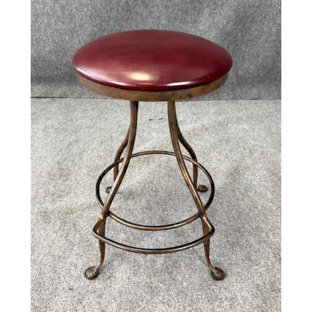 This Charleston Forge Leather and Iron Stool features a hand-forged iron frame with gracefully curved legs and a rich...