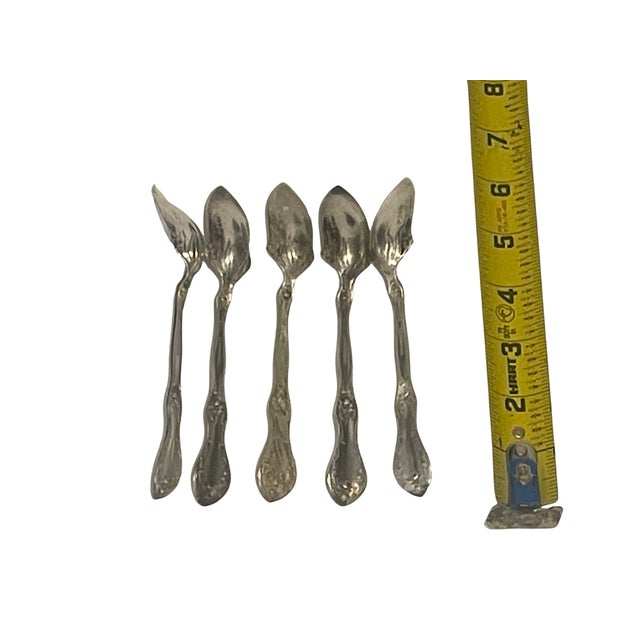 An exquisite set of five antique citrus or grapefruit spoons in the iconic "Florette" pattern, originally introduced in...