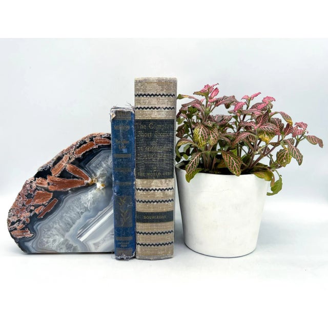 Large and stunning bookend made from a geode. Lovely blue and gray tones with gorgeous veins of light crystals and some...
