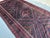 A dramatic antique herati Baluch tribal gallery runner — three massive concentric diamond medallions radiate outward in...