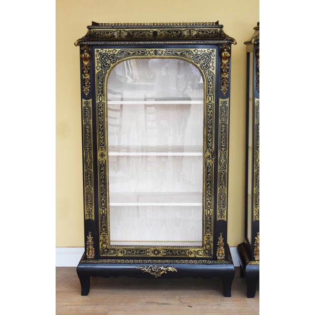 For sale is a good pair of 19th century Victorian ebonized Boulle cabinets. Each cabinet has a brass gallery to the top,...