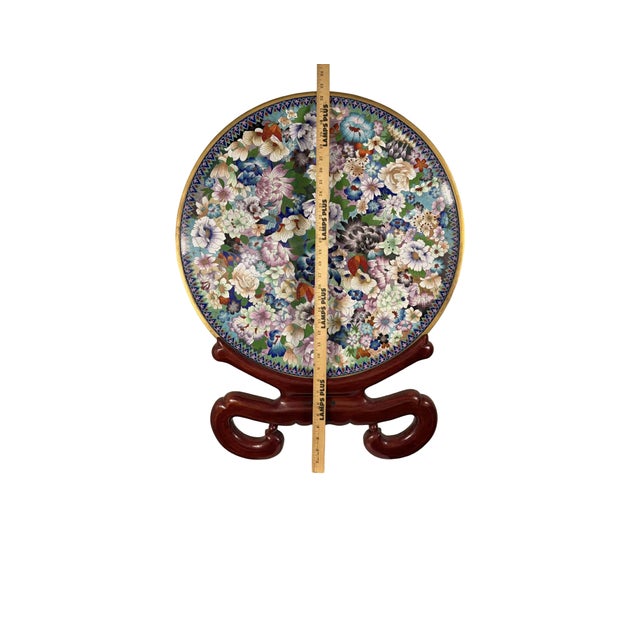 Large Chinese cloisonné enamel charger on brass, featuring a vibrant “thousand flowers” design on a turquoise ground....
