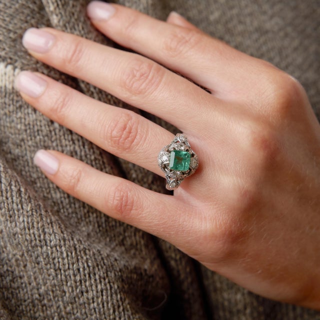 A striking expression of 1930s sophistication, this Art Deco platinum ring showcases a vivid square emerald cut emerald at...