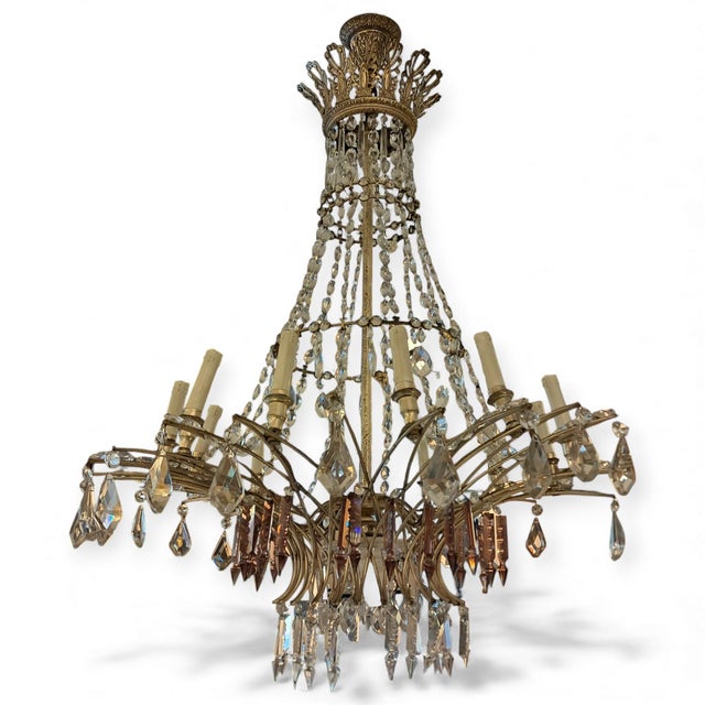French Empire-era chandelier made in France in the early 19th century. It features several tiers with hand-cut crystal...