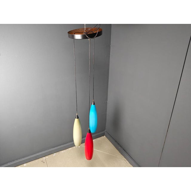 Vintage tricolor pendant lighs by Vistosi. This chandelier or pendant lights are made out of italian glass attached to an...