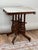 This Antique Walnut Eastlake Victorian Tetrapod Marble Top Table, dating from around 1880, features a striking blend of...