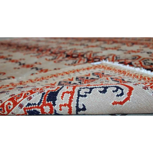 This vintage Uzbek Bukhara rug made in original good condition from the middle of 20th century. The rug is thin, fine...