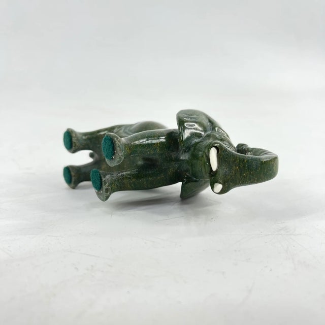 This hand-carved verdite elephant is a striking example of Shona sculpture from Zimbabwe. Crafted from richly colored...
