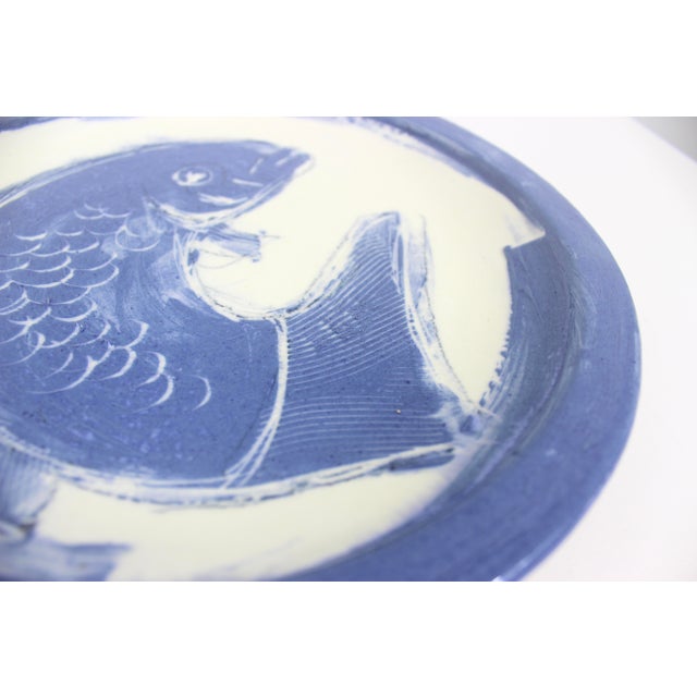 Vintage hand painted Koi fish blue and white pottery plate. Has some texture. Signed on the back. No damage 10 5/8” wide...