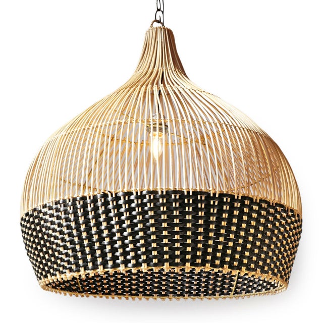 Hand woven pendant light crafted from natural wicker with a striking two-tone weave. The open vertical ribs taper...