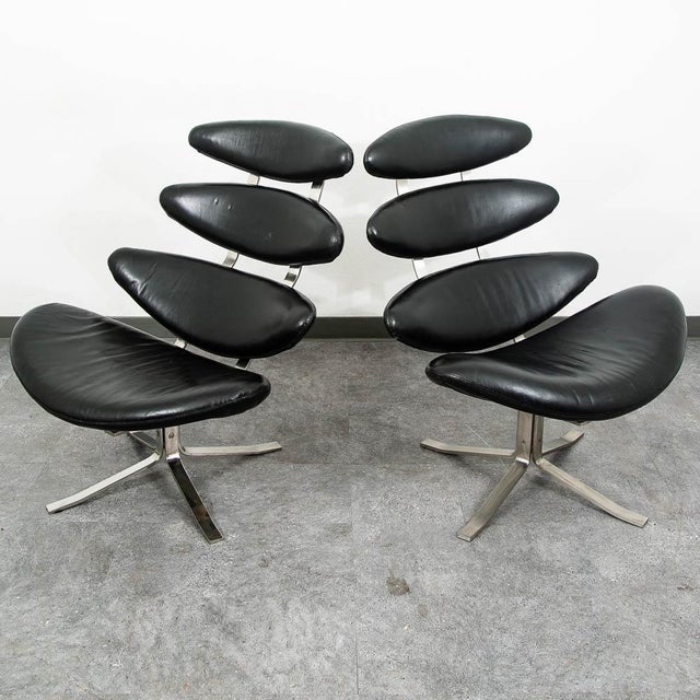 Pair of black leather and chrome Corona chairs with matching ottoman. Unique and high-quality pieces. Unmarked examples....